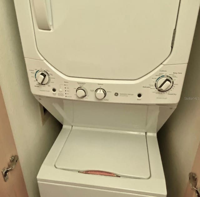 washroom featuring stacked washer and dryer