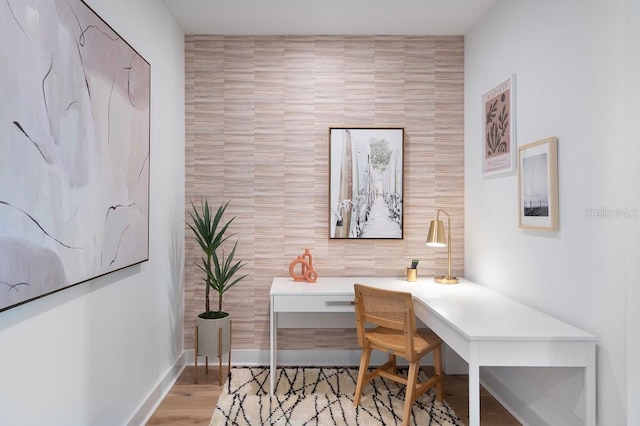 office area with tile walls and light hardwood / wood-style floors