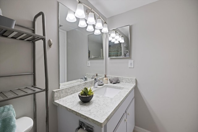 bathroom featuring vanity and toilet