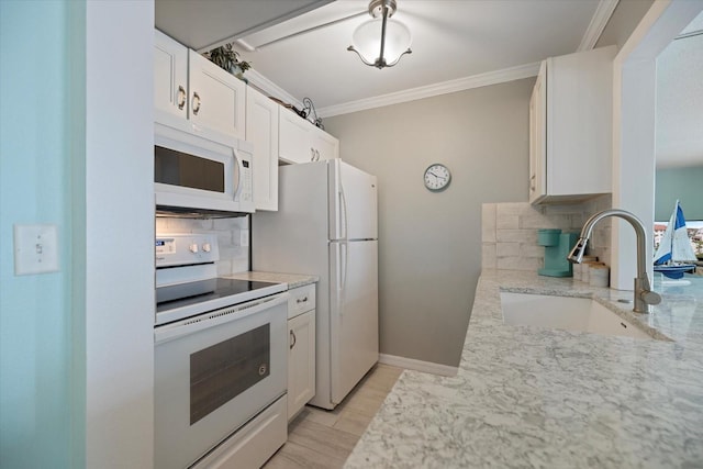 kitchen featuring white cabinetry, white appliances, sink, and decorative backsplash