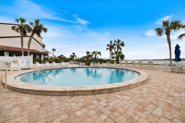 view of swimming pool with a patio