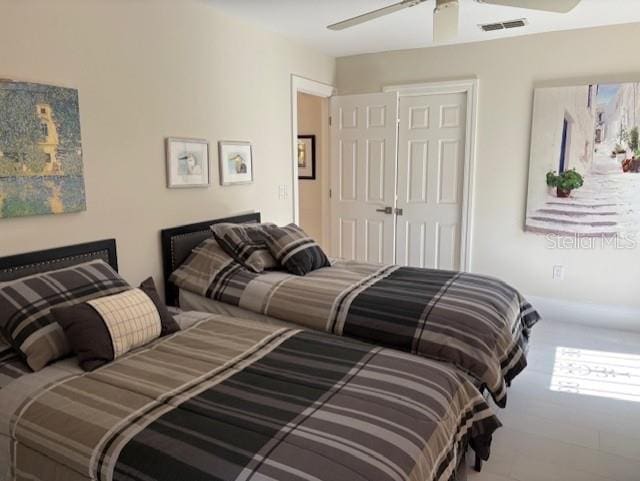 bedroom featuring ceiling fan and a closet