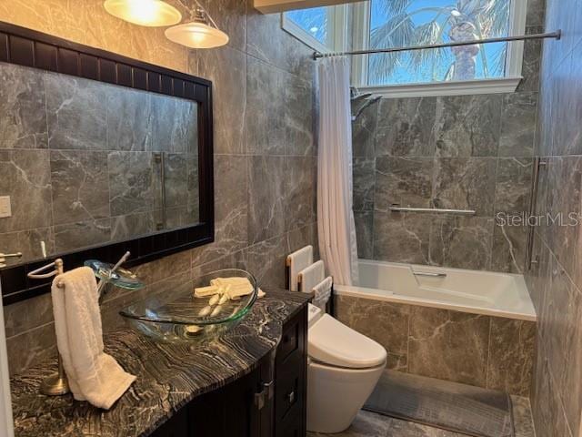 bathroom with decorative backsplash, toilet, shower / tub combo, and tile walls