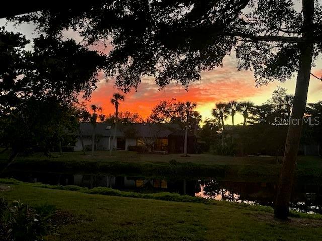 yard at dusk with a water view