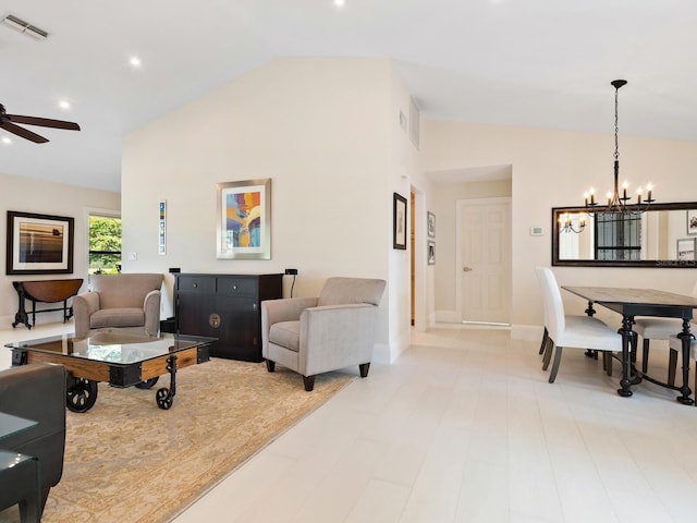 living room featuring ceiling fan with notable chandelier and high vaulted ceiling