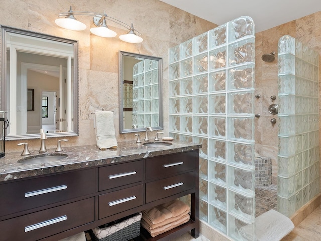 bathroom with vanity and a tile shower