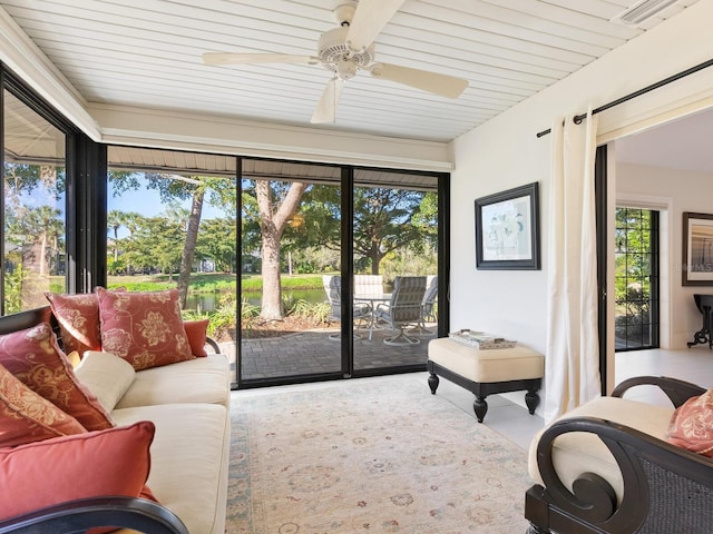 sunroom featuring ceiling fan