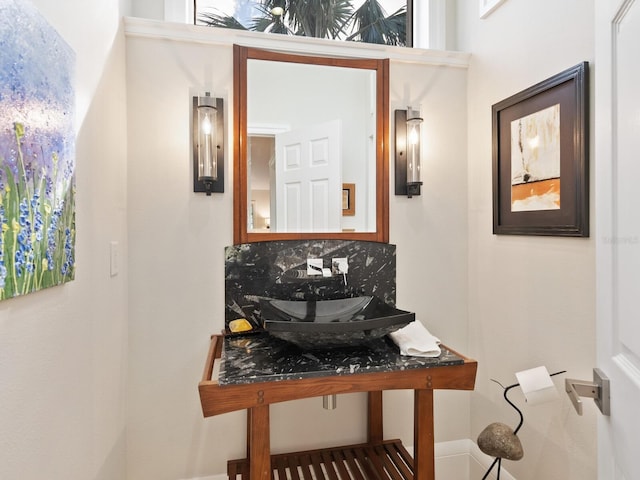 bathroom with tasteful backsplash and sink