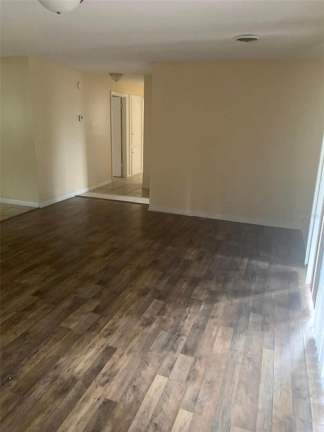 unfurnished room featuring dark wood-type flooring