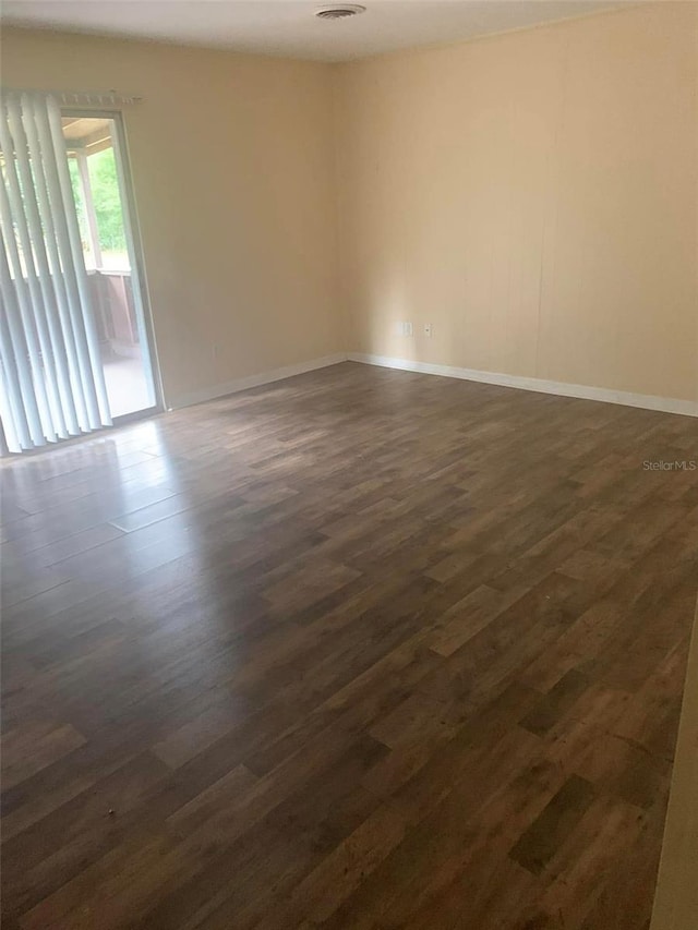 empty room with dark hardwood / wood-style floors