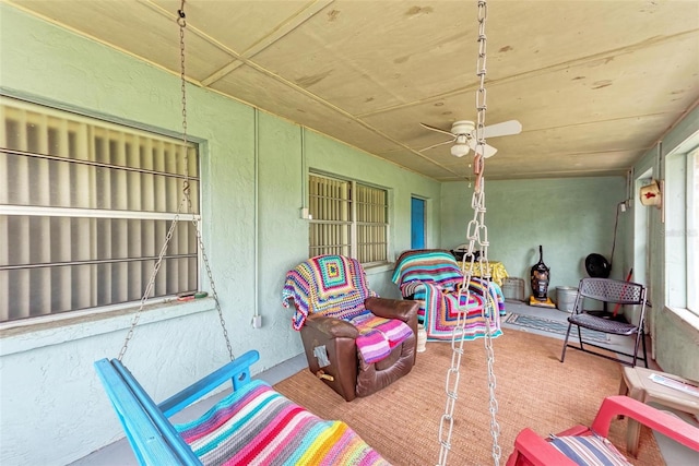 sunroom featuring ceiling fan