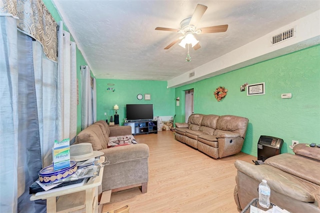 living room featuring light hardwood / wood-style floors and ceiling fan