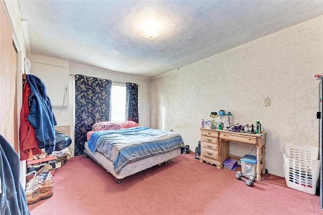 carpeted bedroom featuring a textured ceiling