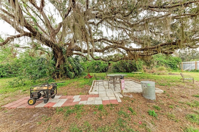 view of yard featuring a patio and an outdoor fire pit