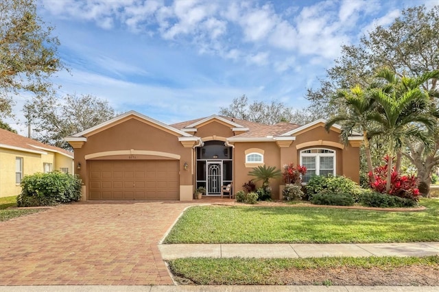 single story home with a garage and a front yard