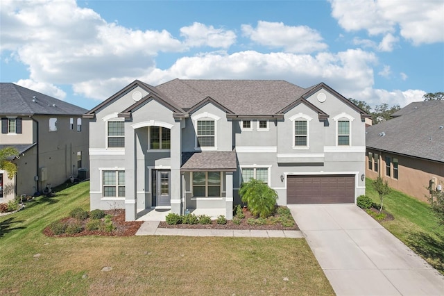 view of front of property with a garage and a front yard