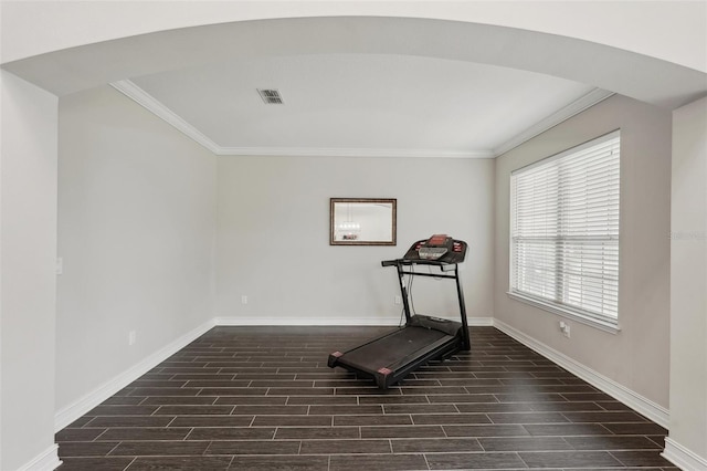 exercise area featuring crown molding