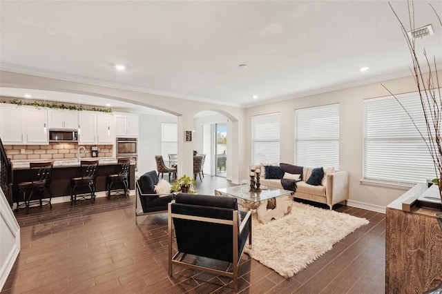 living room featuring crown molding and dark wood-type flooring