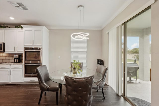 dining area featuring crown molding and a chandelier