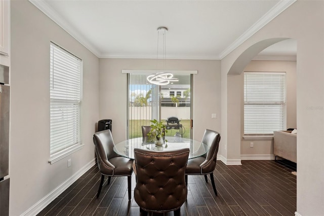 dining area with an inviting chandelier and ornamental molding