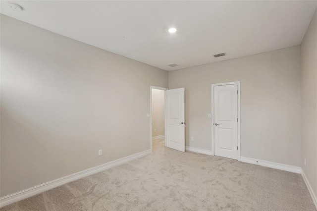 unfurnished bedroom featuring light carpet