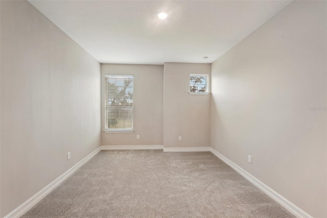 unfurnished room with light colored carpet