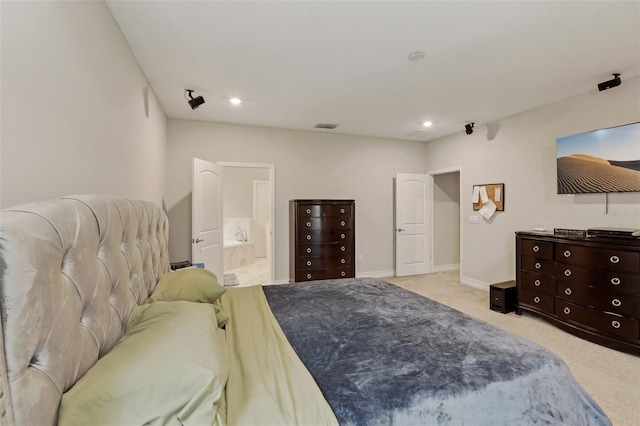 carpeted bedroom with connected bathroom