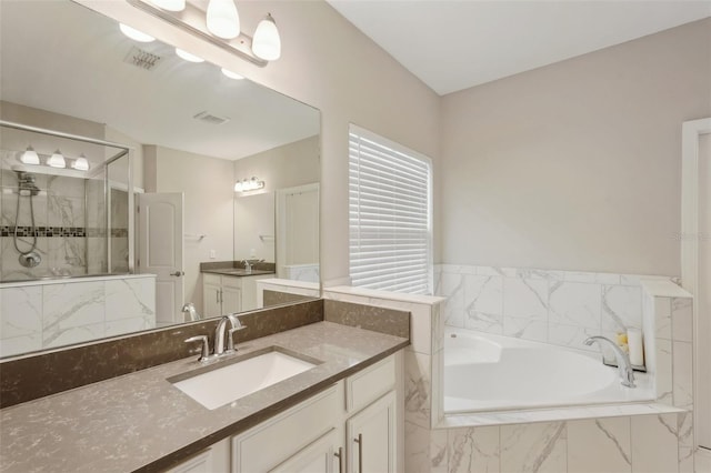 bathroom featuring vanity and plus walk in shower