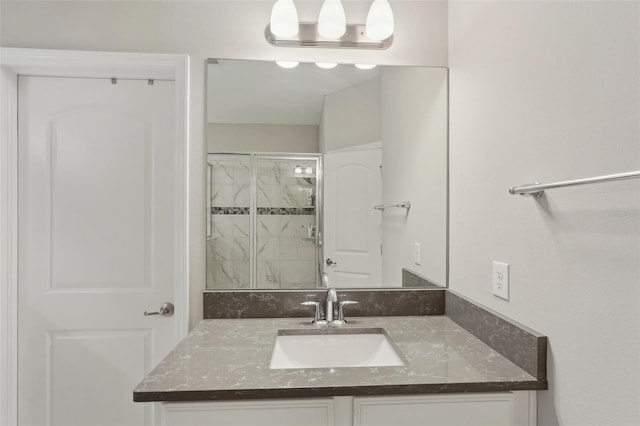 bathroom with vanity and a shower with door