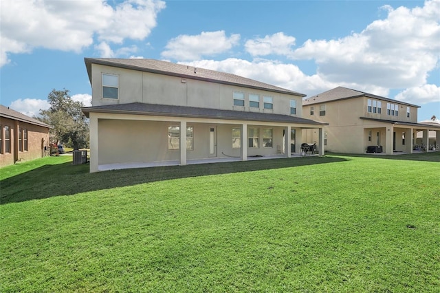 back of house with a patio area, central air condition unit, and a lawn