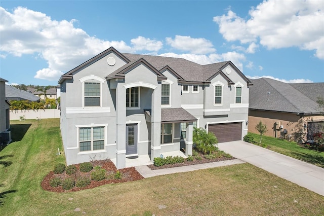 view of front of property with a garage and a front lawn