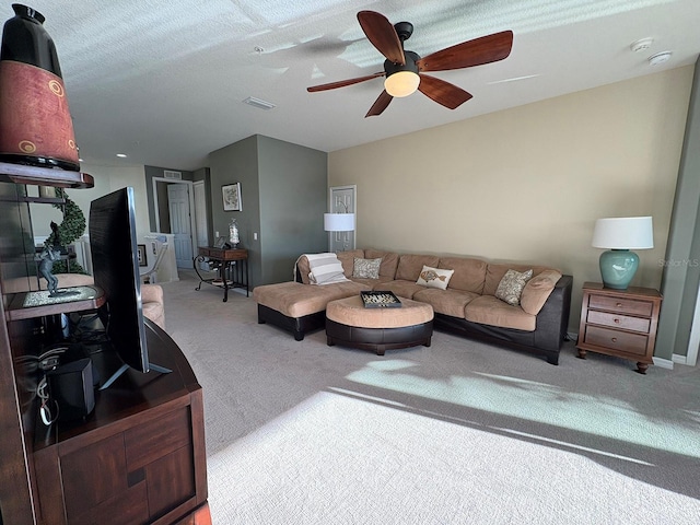 living room featuring carpet and ceiling fan