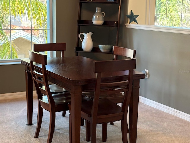 dining room featuring light colored carpet