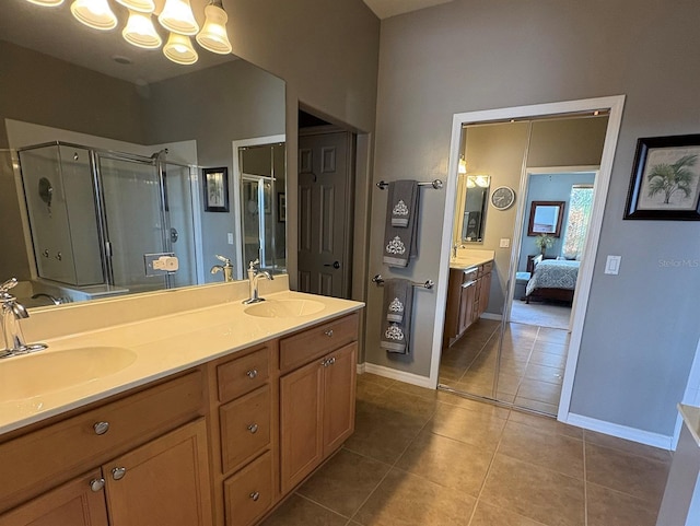 bathroom featuring vanity, tile patterned flooring, and a shower with shower door