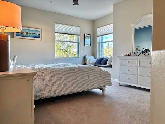 carpeted bedroom featuring ceiling fan