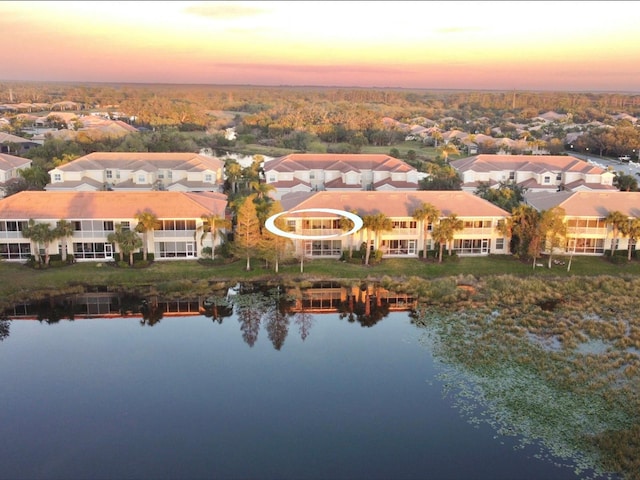 aerial view at dusk with a water view