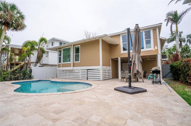 back of house with a fenced in pool and a patio area