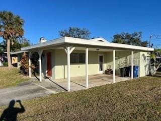 exterior space featuring a front yard and a carport