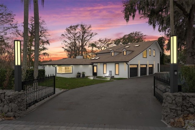 modern inspired farmhouse featuring a fenced front yard, a front yard, and driveway