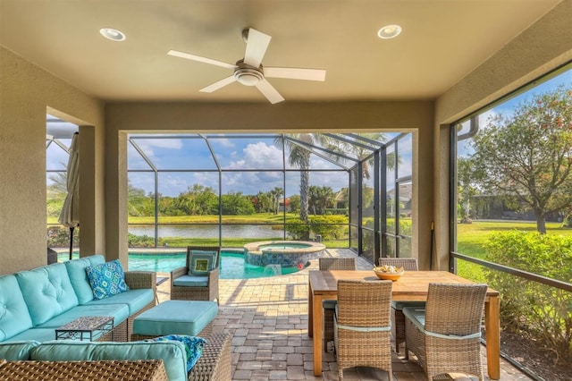 sunroom / solarium with a water view and ceiling fan