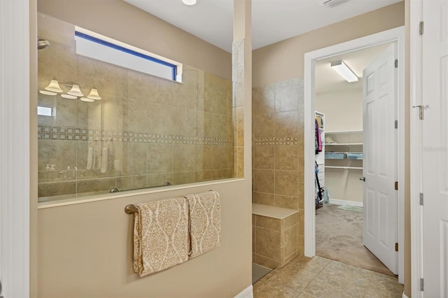 bathroom with a tile shower