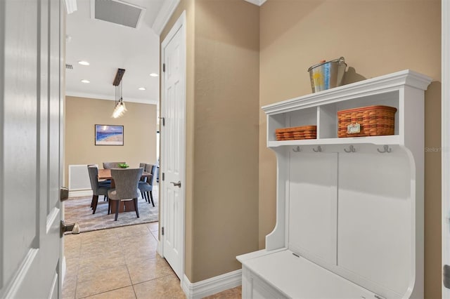 mudroom featuring crown molding and light tile patterned floors