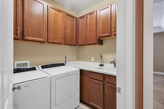 laundry area featuring cabinets, light colored carpet, separate washer and dryer, and sink