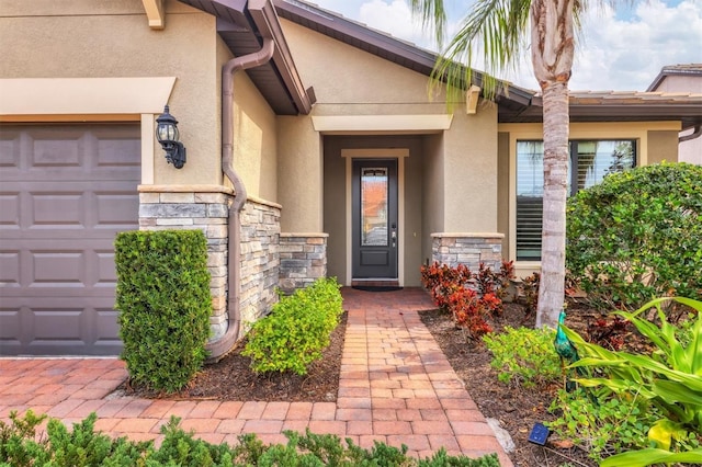 doorway to property with a garage