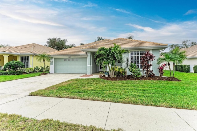 ranch-style house featuring a garage and a front yard