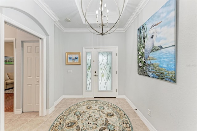 tiled entrance foyer featuring crown molding and a notable chandelier