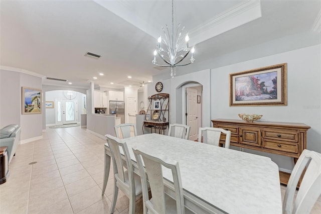 dining space with an inviting chandelier, light tile patterned floors, and ornamental molding