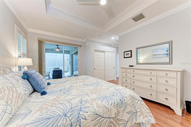 bedroom featuring crown molding, light wood-type flooring, a closet, ceiling fan, and access to exterior