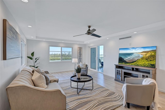 living room with ceiling fan and light wood-type flooring