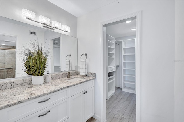 bathroom with vanity and hardwood / wood-style flooring